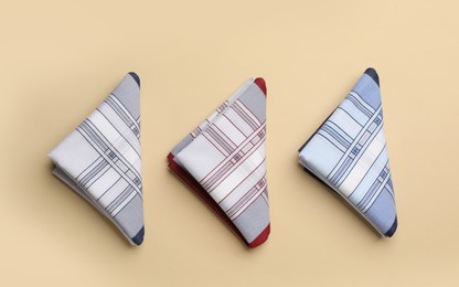 Photo of Stylish handkerchiefs on beige background, flat lay