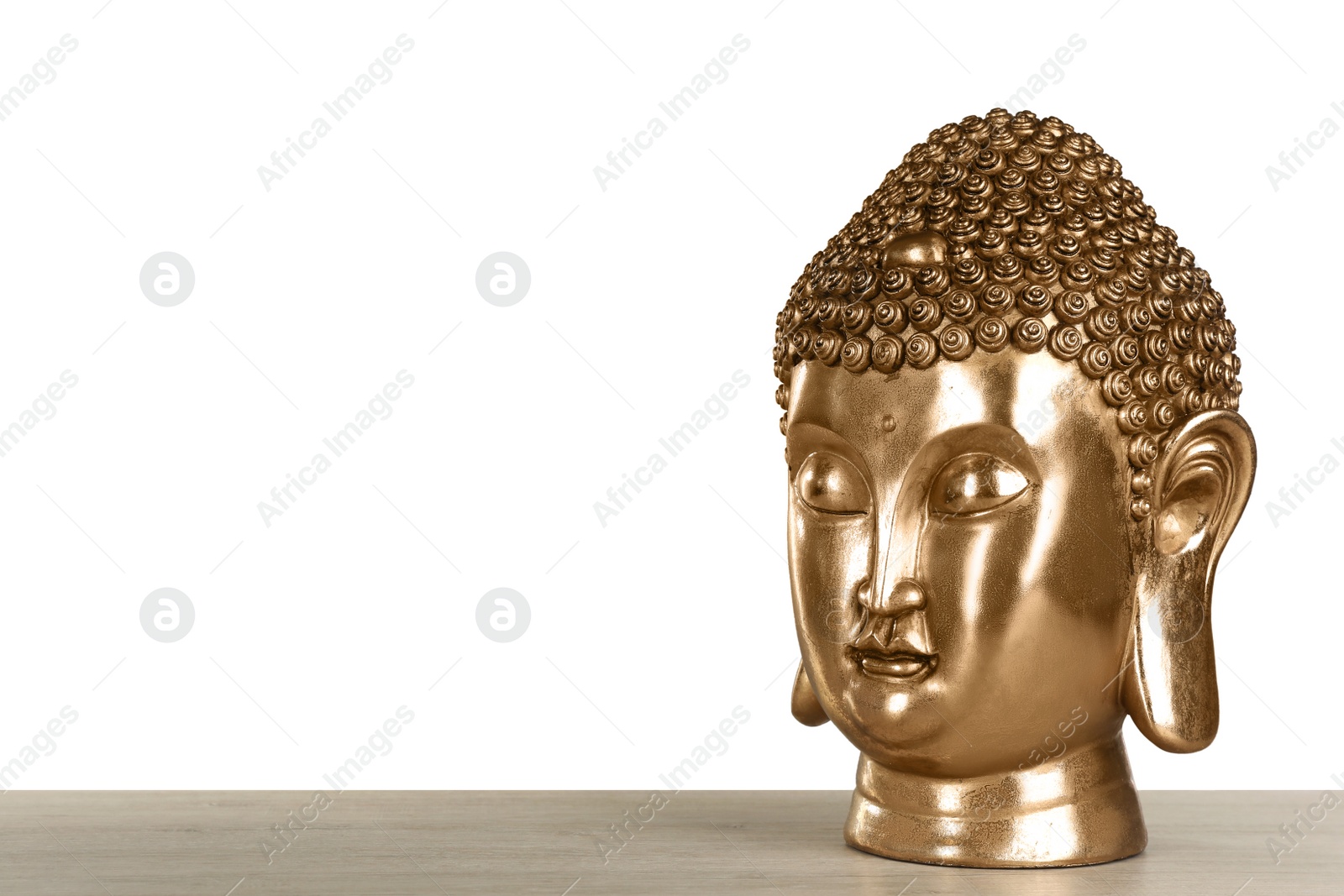 Photo of Beautiful golden Buddha sculpture on wooden table against grey background. Space for text