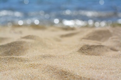 Photo of Sandy beach near sea on sunny day, closeup
