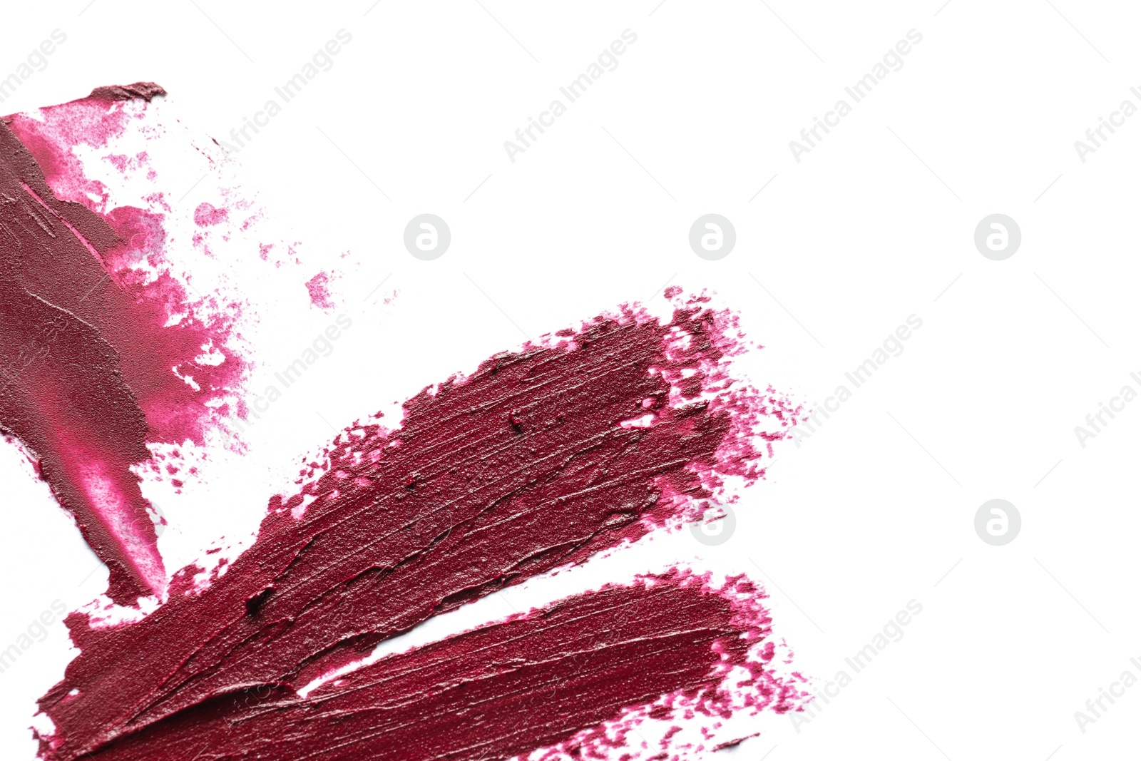 Photo of Lipstick smears on white background, top view. Space for text