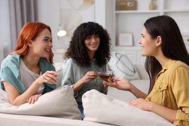 Photo of Happy young friends spending time together at home