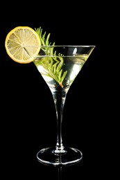 Martini cocktail with lemon slice and rosemary on black background