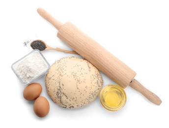 Photo of Raw dough with poppy seeds, rolling pin and ingredients on white background, top view