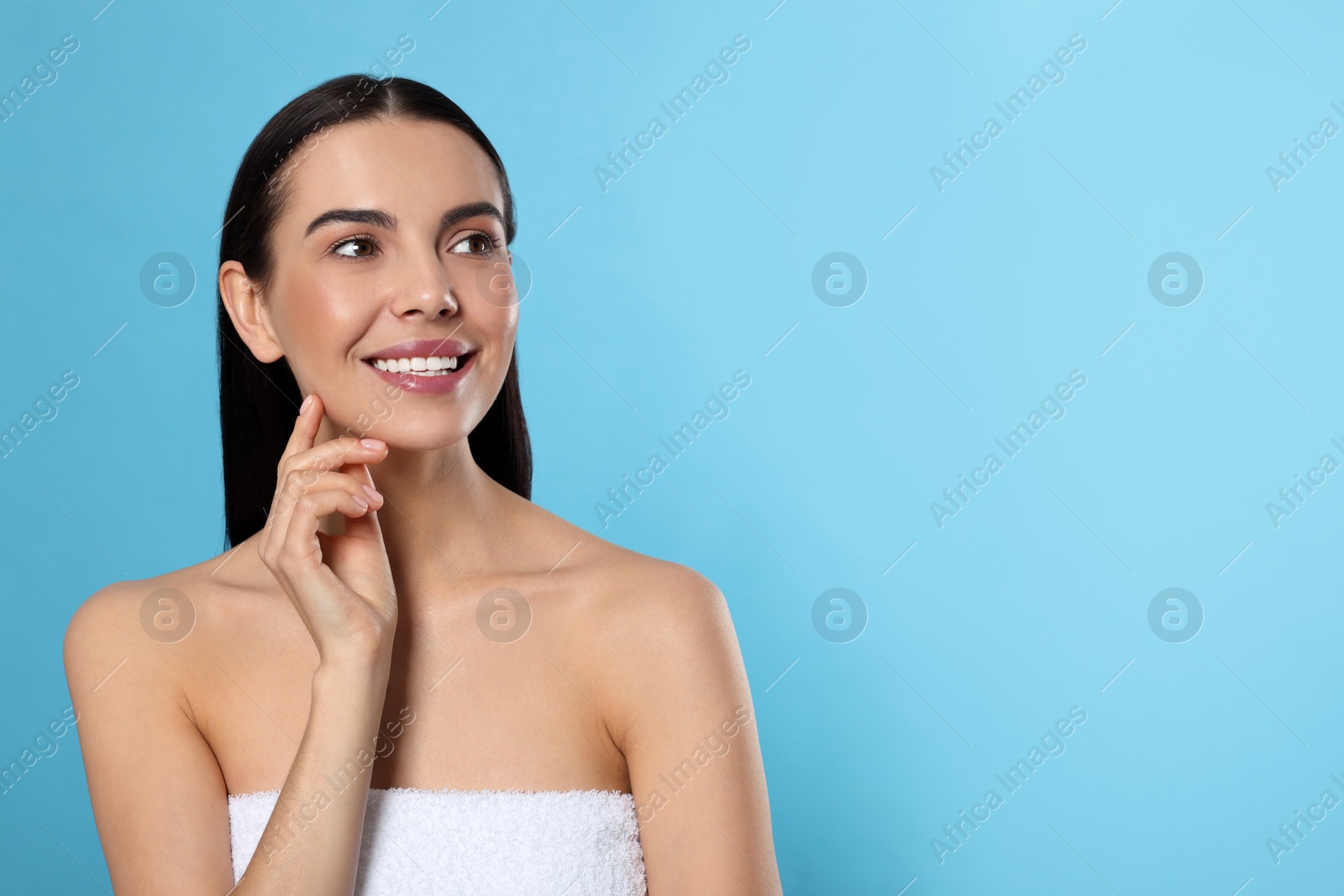 Photo of Portrait of attractive young woman on light blue background, space for text. Spa treatment