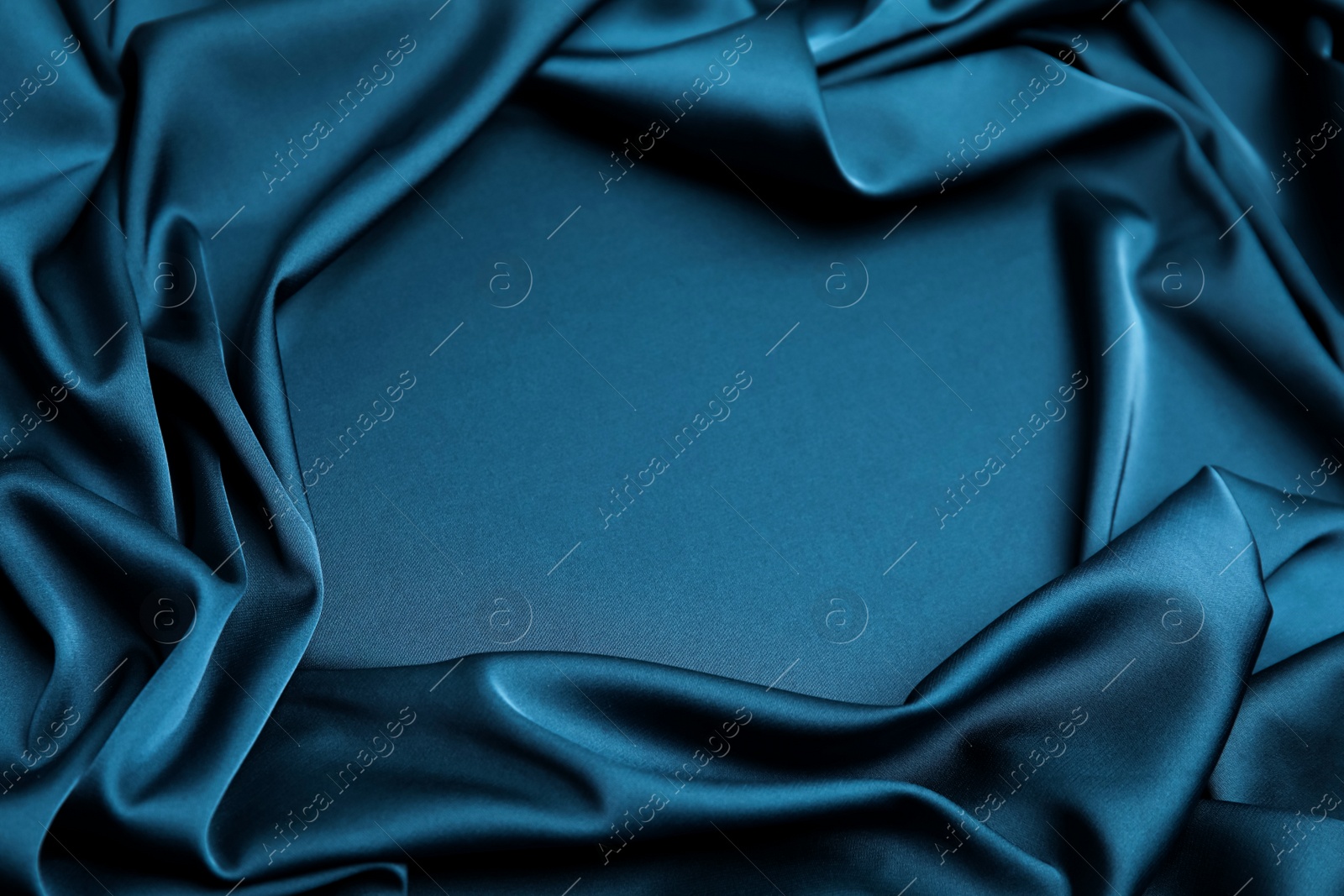 Image of Crumpled dark blue silk fabric as background, closeup view. Space for text