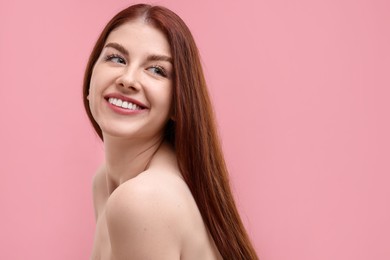 Photo of Portrait of smiling woman with freckles on pink background. Space for text