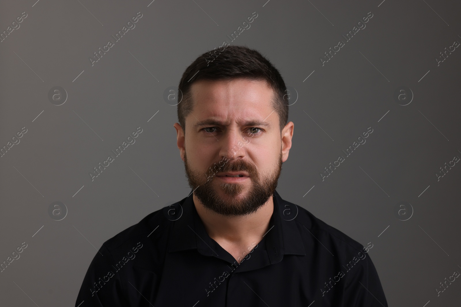 Photo of Personality concept. Emotional man on grey background