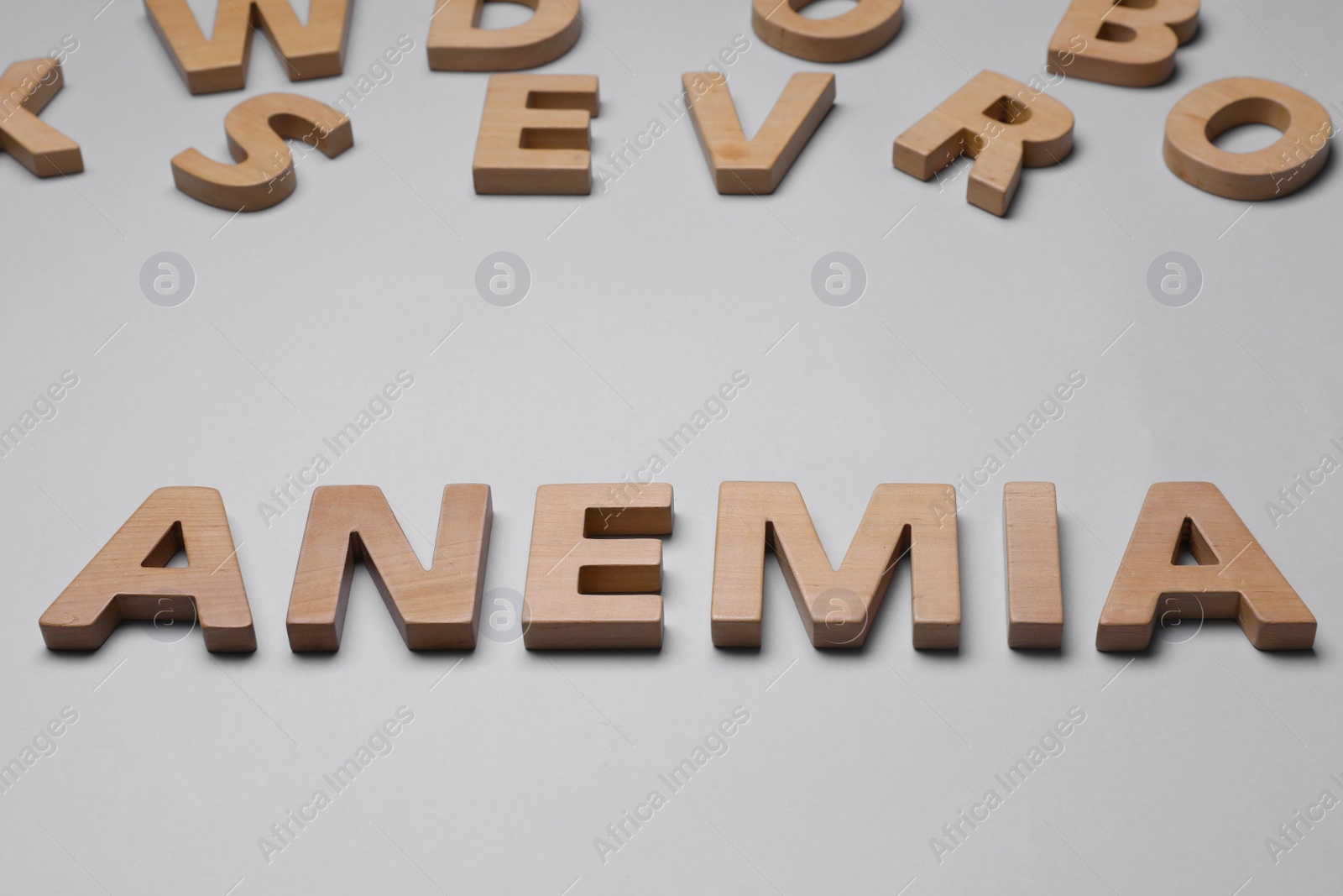 Photo of Word Anemia made of wooden letters on grey background