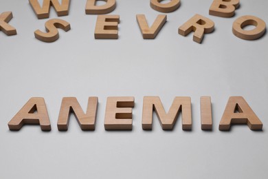 Photo of Word Anemia made of wooden letters on grey background