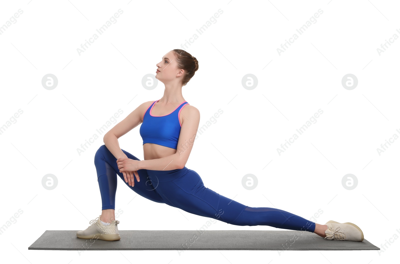 Photo of Yoga workout. Young woman stretching on white background