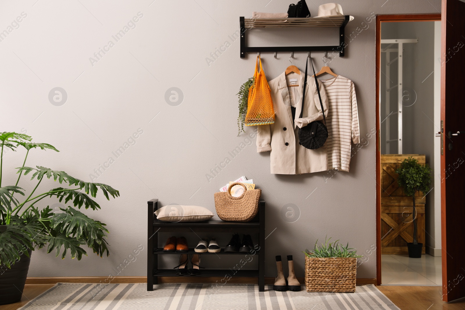 Photo of Hallway interior with stylish furniture, clothes and accessories