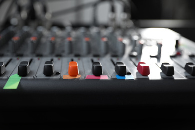 Photo of Modern audio mixing console, closeup. Music equipment