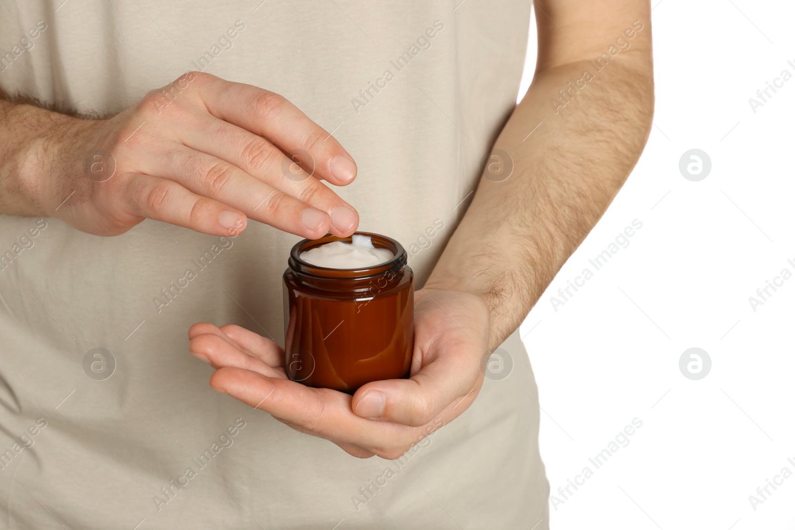 Photo of Man holding jar of hand cream on white background, closeup