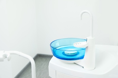 Photo of Clean spit sink in dentist's office. Space for text