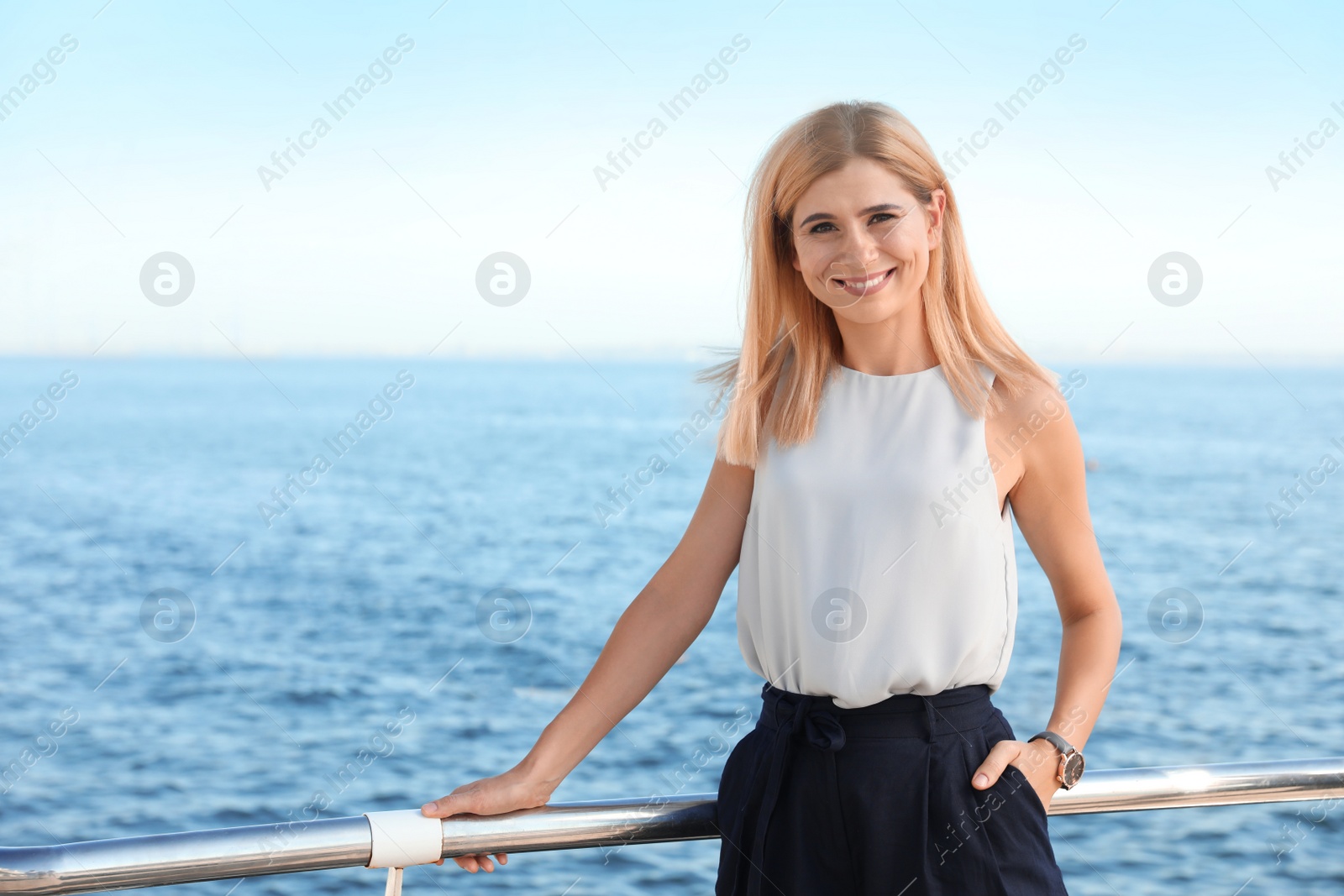 Photo of Portrait of beautiful blonde woman near sea, space for text