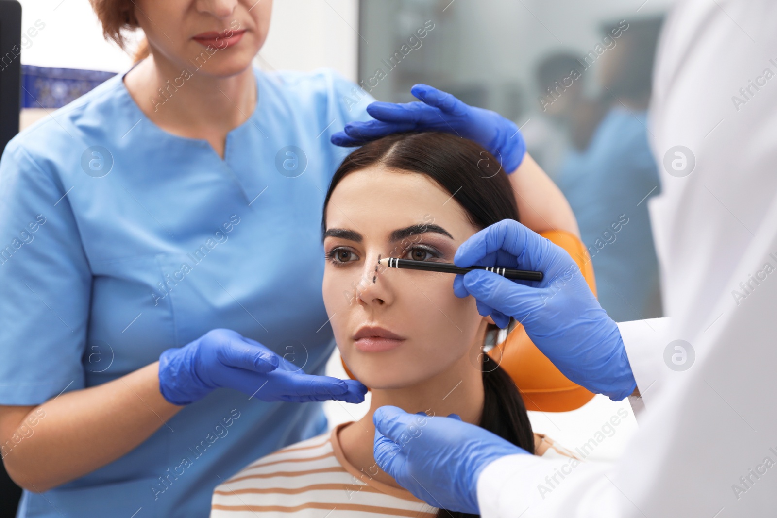 Photo of Professional doctors examining patient before surgery in clinic