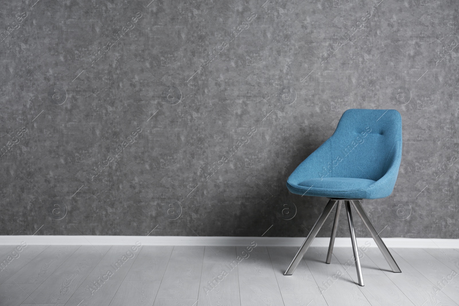 Photo of Blue modern chair for interior design on wooden floor at gray wall