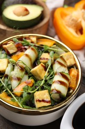 Photo of Delicious salad with tofu, vegetables and balsamic vinegar on table, closeup