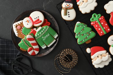 Photo of Delicious Christmas cookies on black table, flat lay