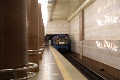 Photo of Train pulling out of subway station, blurred view. Public transport
