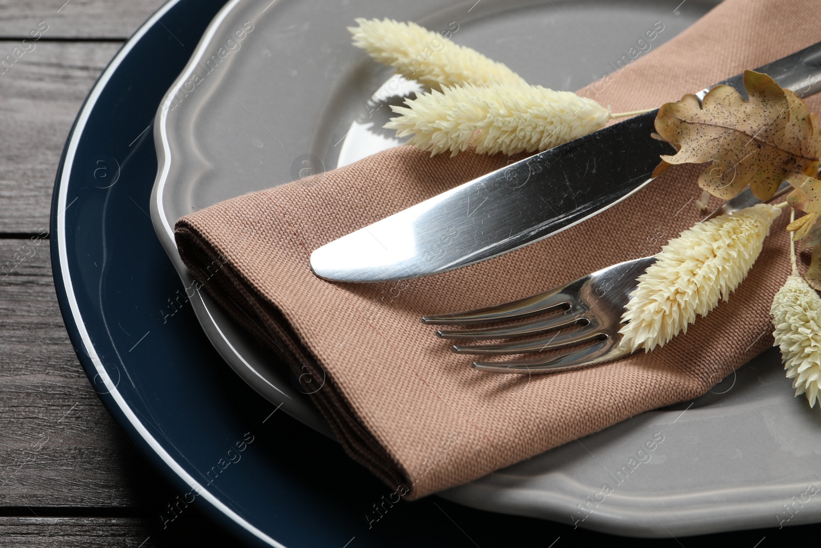 Photo of Autumn table setting on wooden background, closeup