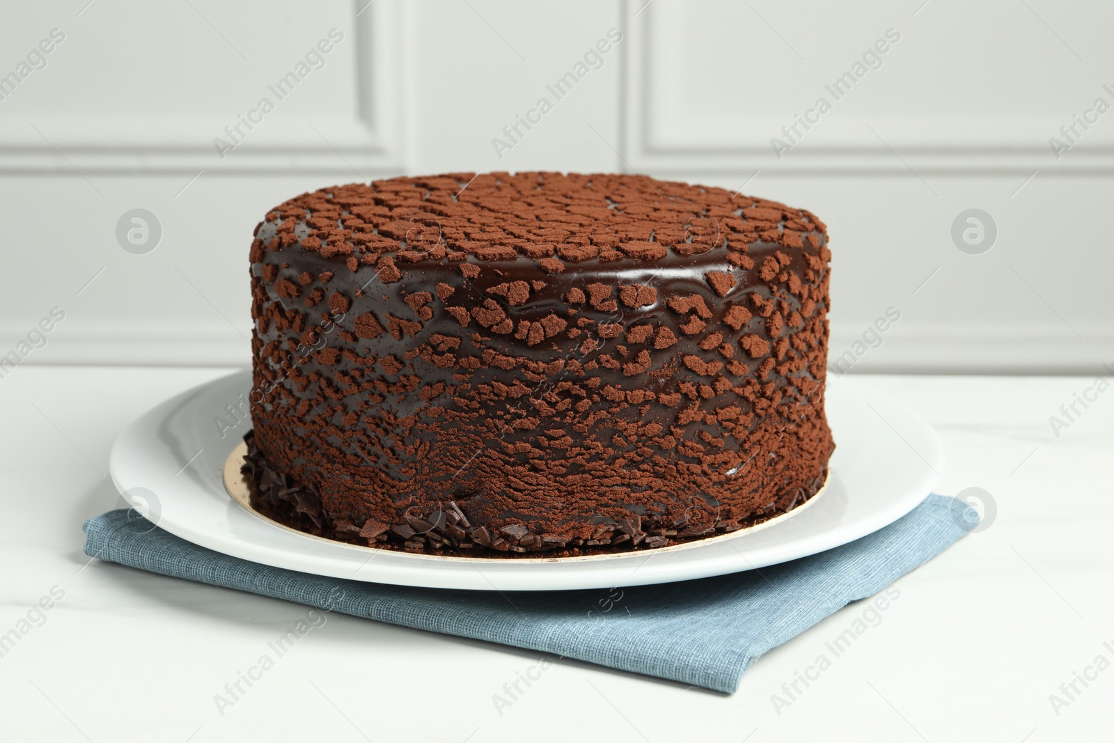 Photo of Delicious chocolate truffle cake on white marble table