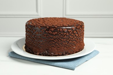 Delicious chocolate truffle cake on white marble table