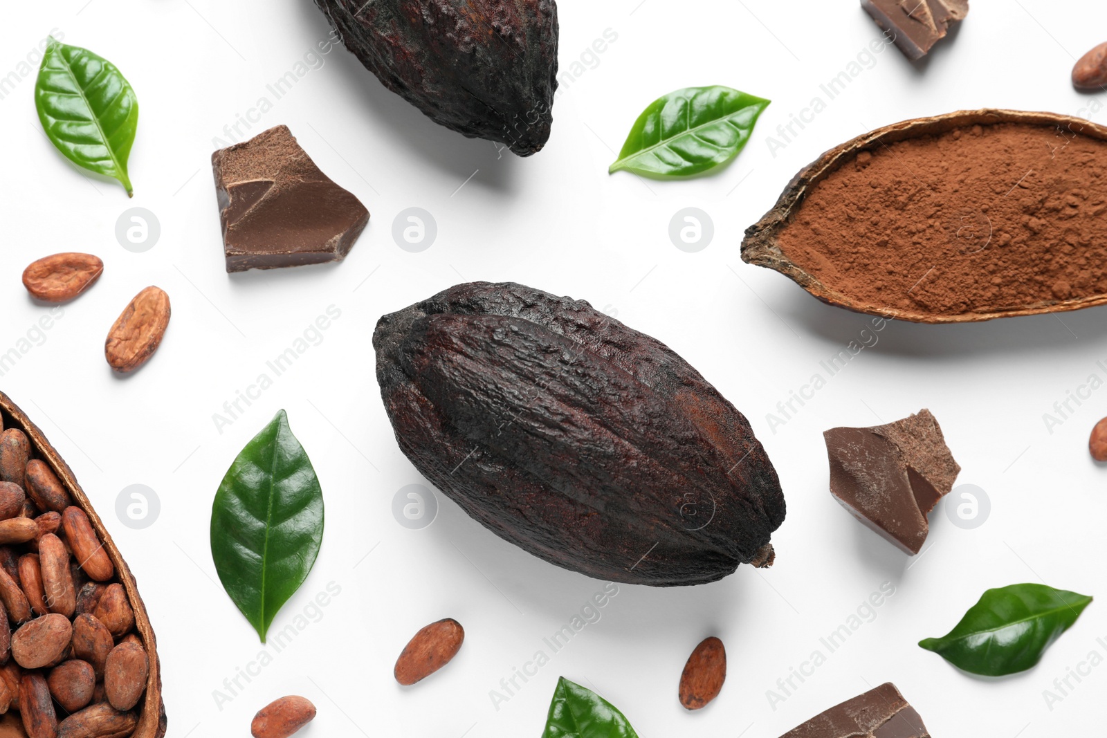 Photo of Cocoa pods with beans, powder and chocolate pieces on white background, top view