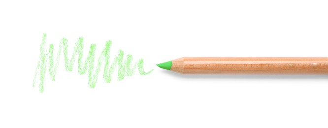 Photo of Light green pastel pencil and scribble isolated on white, top view. Drawing supply