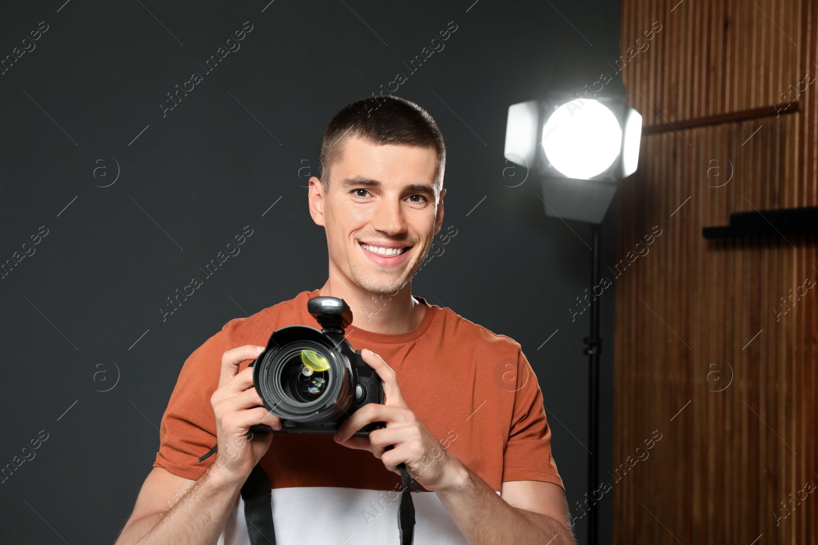 Photo of Professional photographer with modern camera in studio