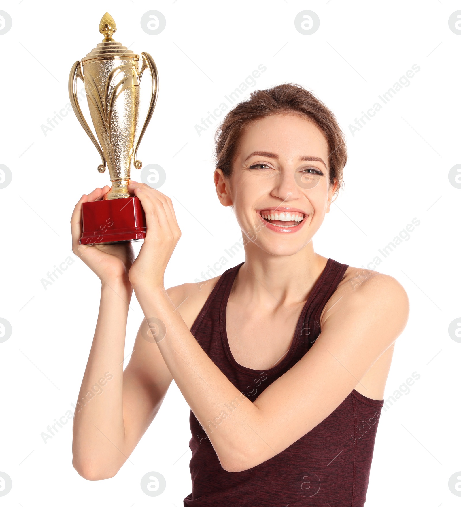 Photo of Portrait of happy young sportswoman with gold trophy cup on white background