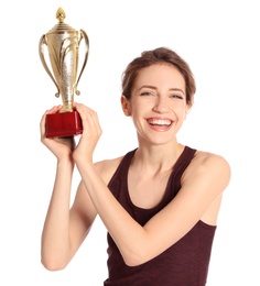 Photo of Portrait of happy young sportswoman with gold trophy cup on white background