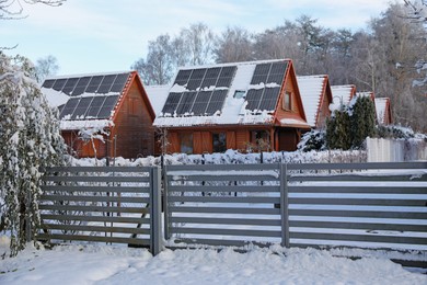 Winter landscape with beautiful houses, trees and bushes in morning