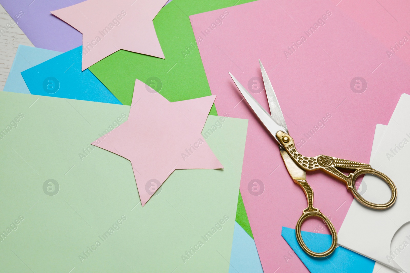Photo of Pair of scissors with colorful paper sheets on white wooden table, flat lay. Space for text