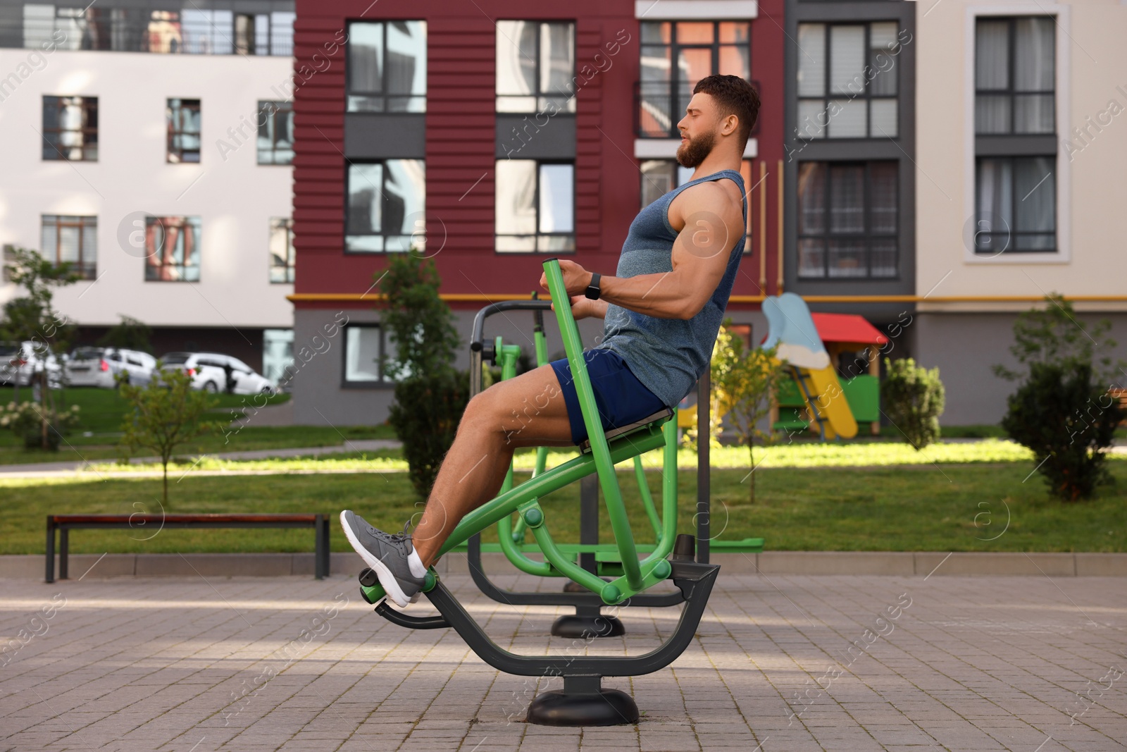 Photo of Man training on rowing machine at outdoor gym