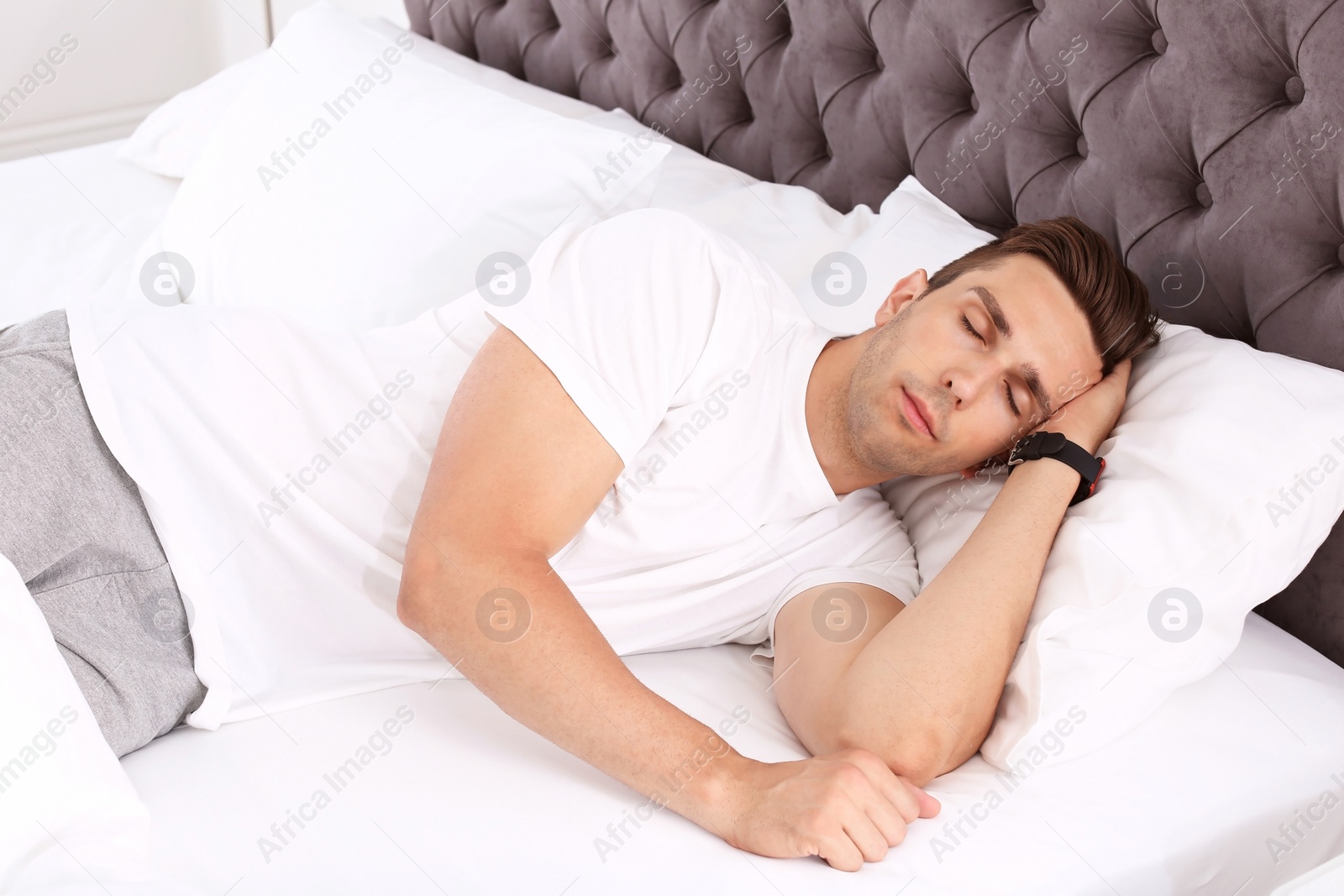 Photo of Young man sleeping in bed at home