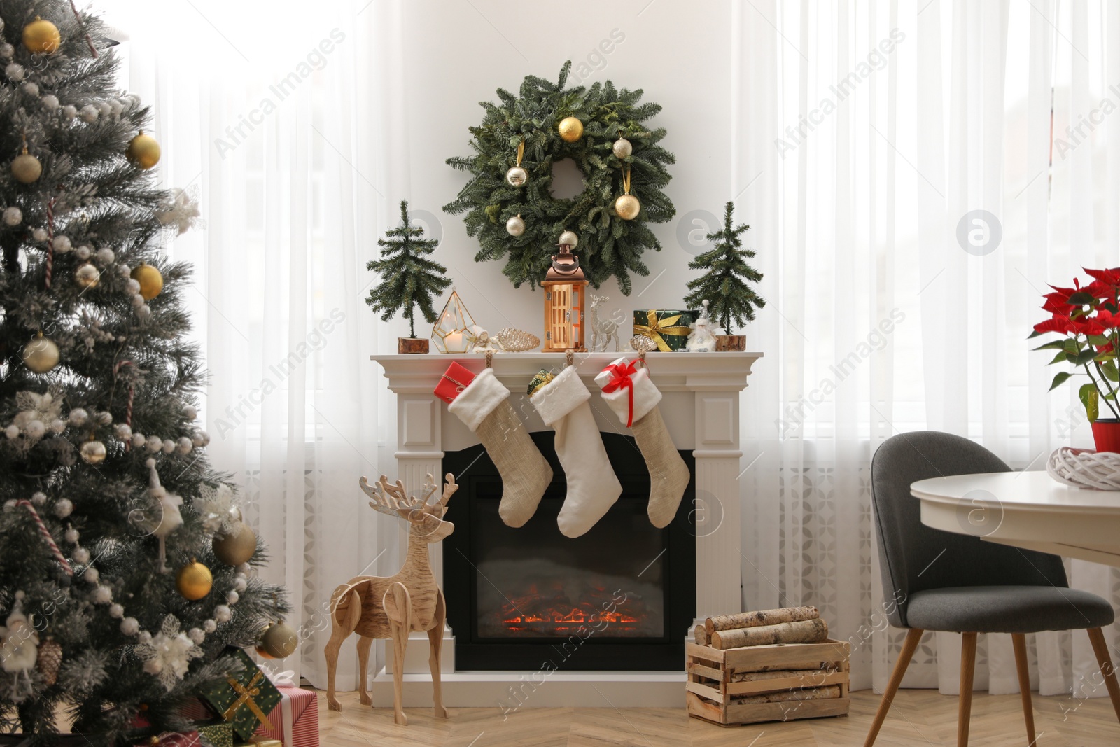 Photo of Fireplace in room with Christmas decorations. Interior design