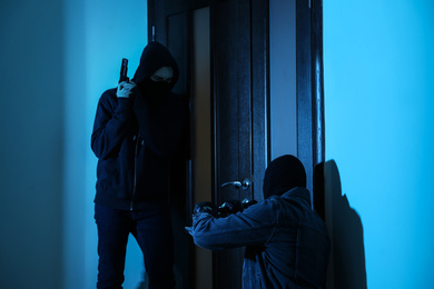 Photo of Dangerous criminals forcing door with crow bar