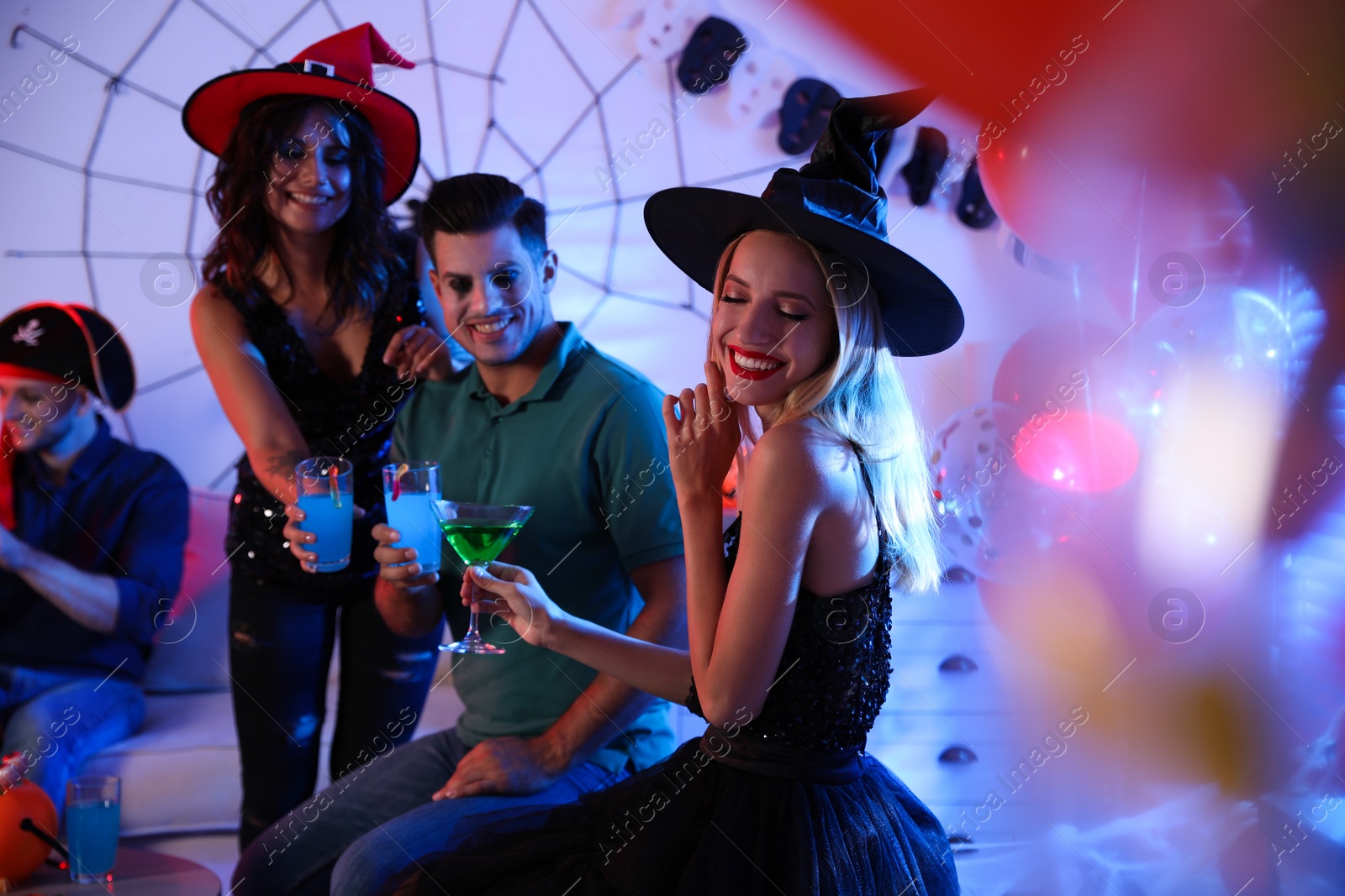 Photo of Group of friends having Halloween party at home