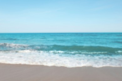 Blurred view of beautiful sea and sandy beach on sunny day