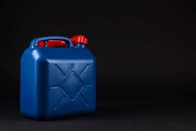 New blue plastic canister on black background. Space for text