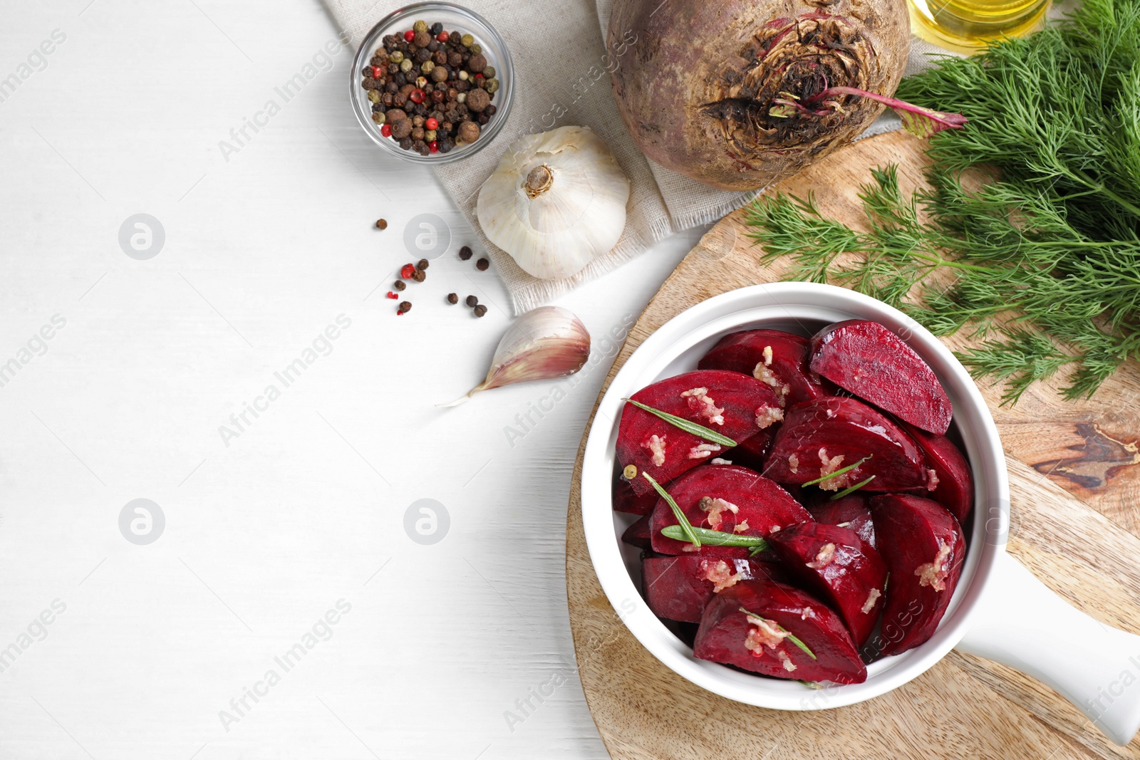 Photo of Flat lay composition with raw beetroot slices on white wooden table. Space for text