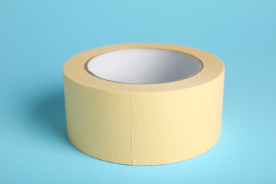 Photo of Roll of adhesive tape on light blue background