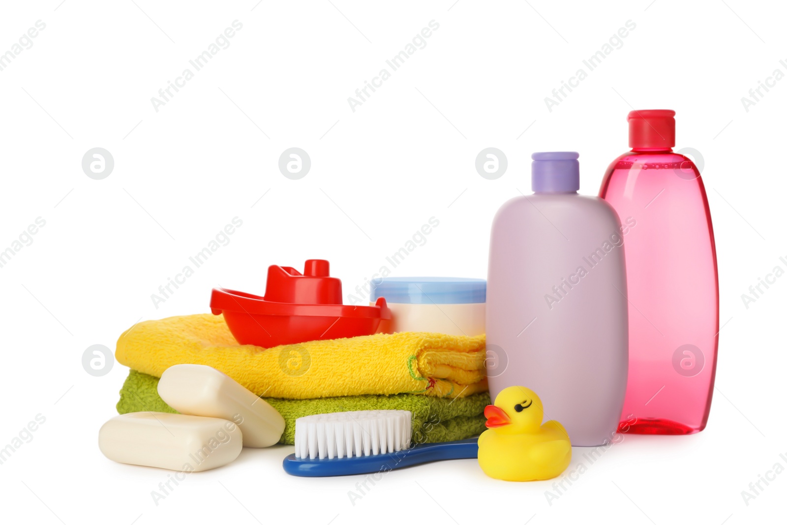 Photo of Baby cosmetic products, toys and towels on white background