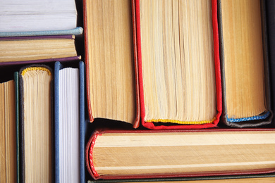 Many different hardcover books as background, top view