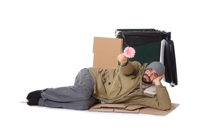 Photo of Poor homeless man with flower near trash bin isolated on white