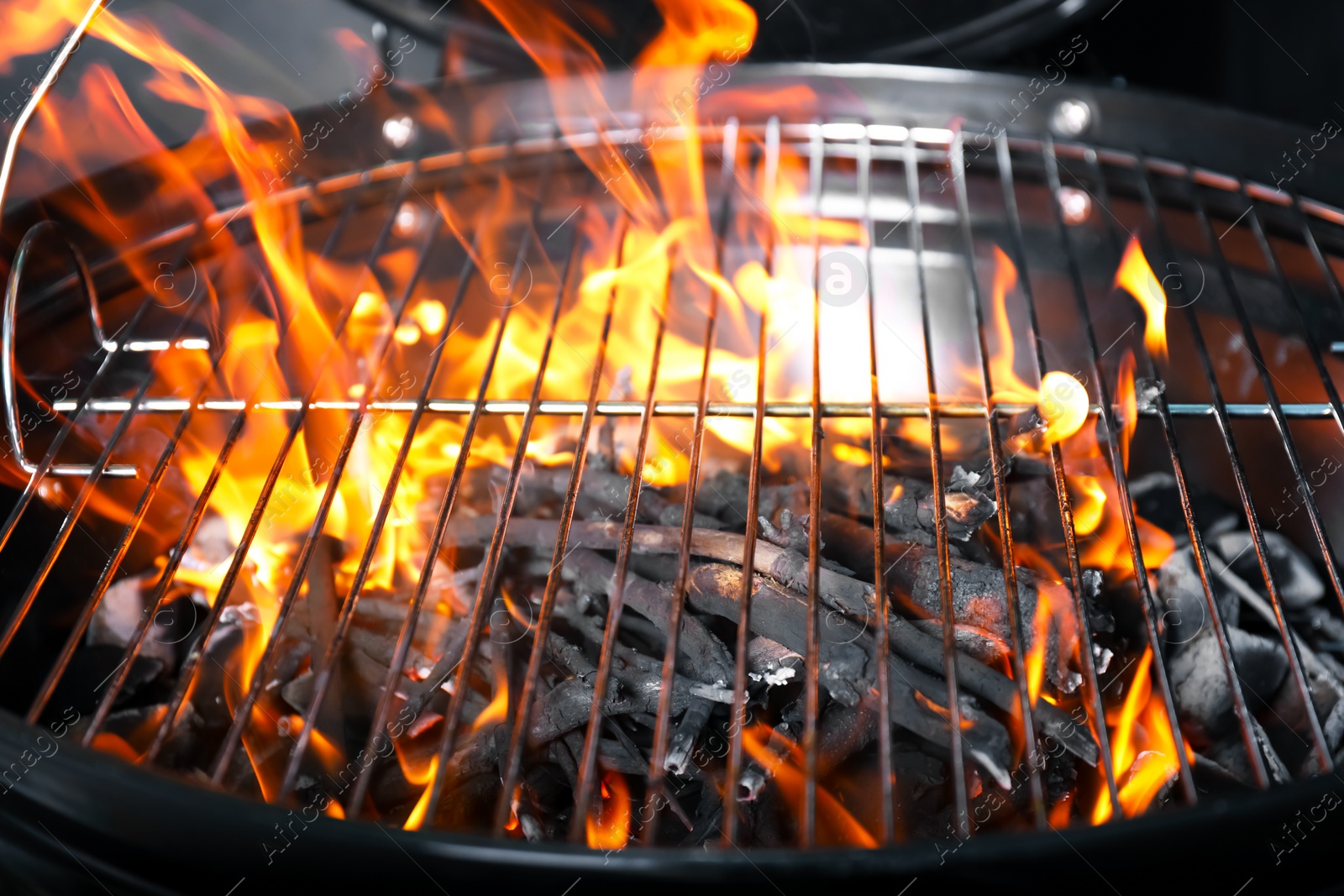 Photo of New modern barbecue grill with coals, closeup