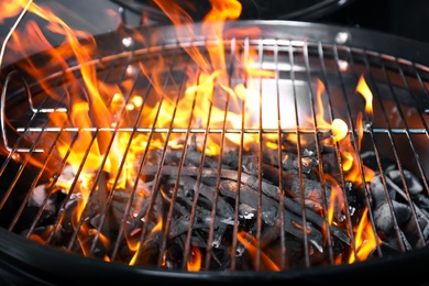 Photo of New modern barbecue grill with coals, closeup