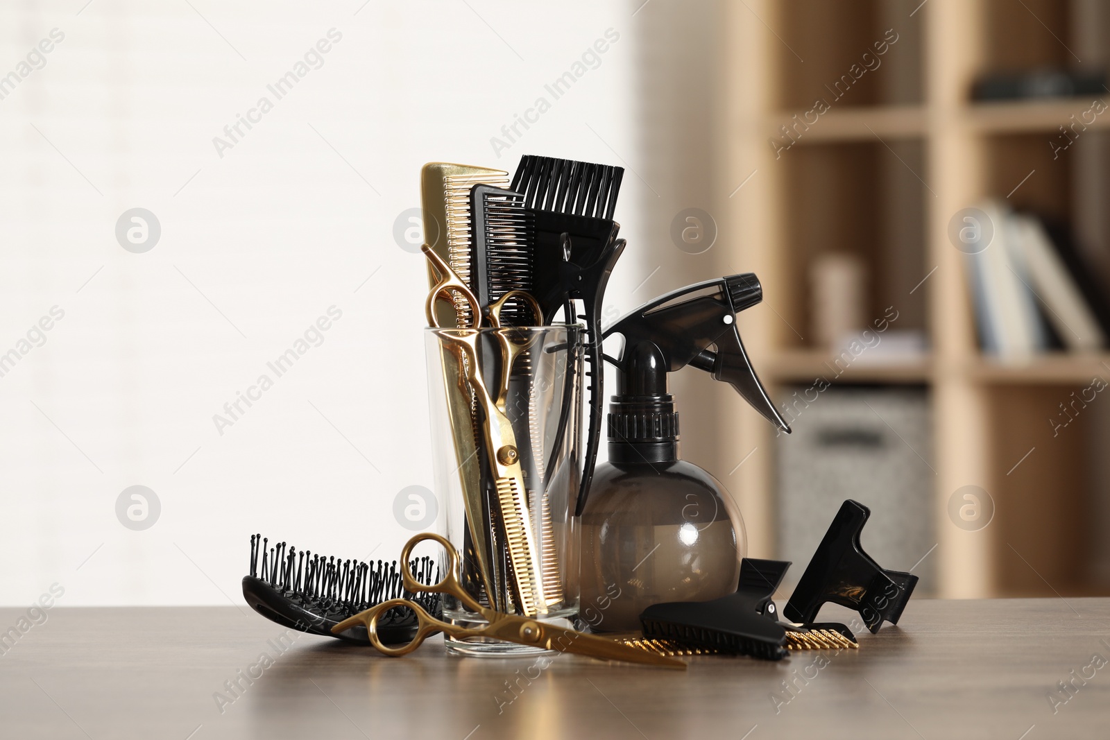 Photo of Set of hairdresser tools on table in salon