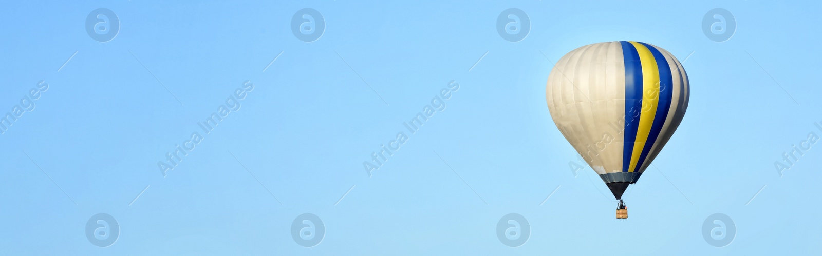 Image of Hot air balloon in blue sky, space for text. Banner design 